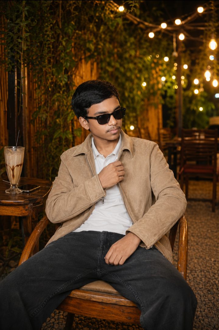 young man sitting on a wooden chair